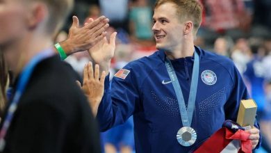 Nic Fink proudly displays his silver medal after an outstanding breaststroke performance at the 2024 Paris Olympics