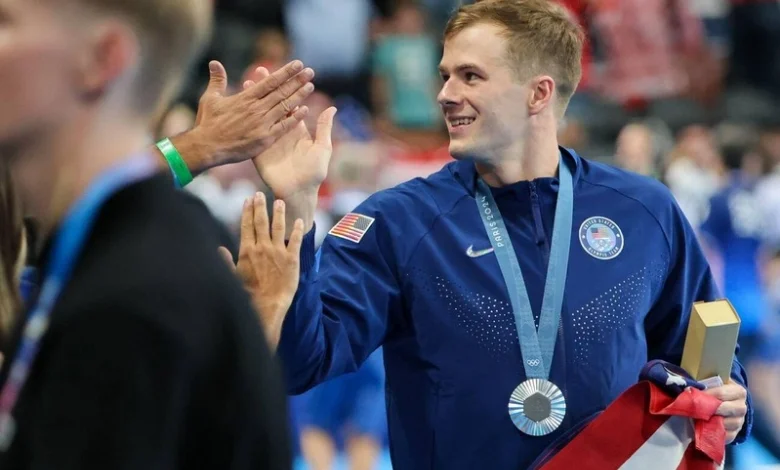 Nic Fink proudly displays his silver medal after an outstanding breaststroke performance at the 2024 Paris Olympics