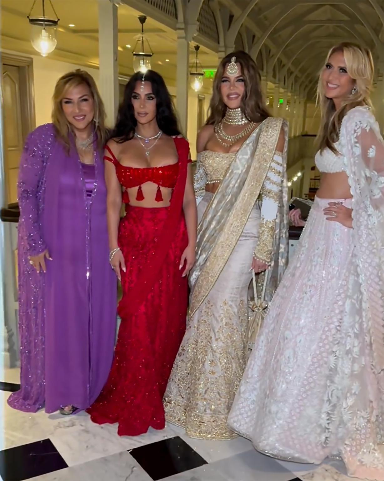 Kim & Khole Kardashian posing with fellow guests