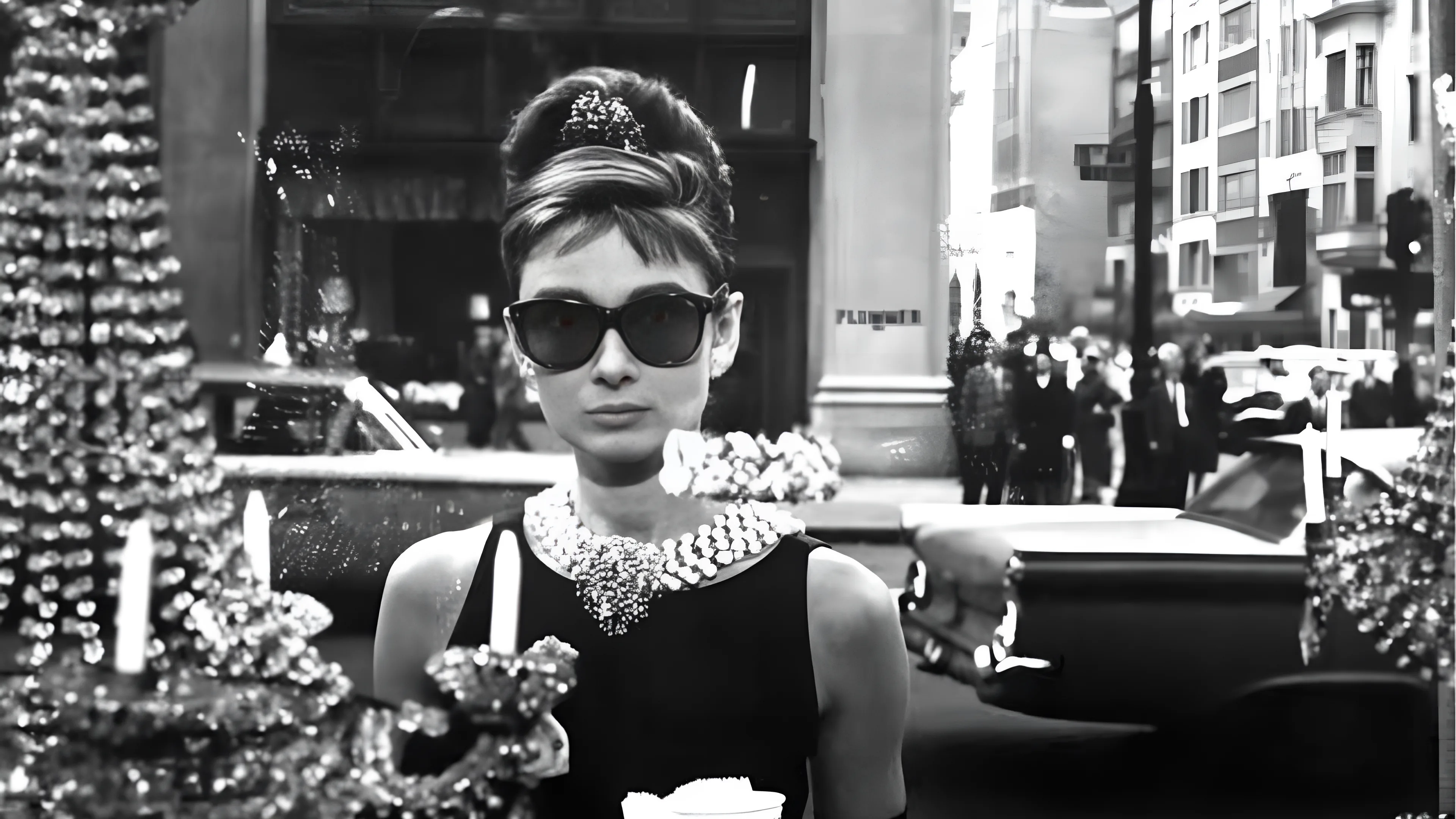 Audrey Hepburn pairing black dresses with sunglasses and diamonds