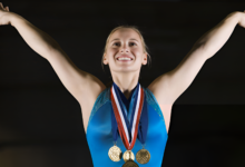 Gold Medalist Gymnast posing after her win