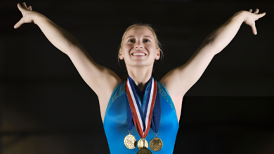 Gold Medalist Gymnast posing after her win