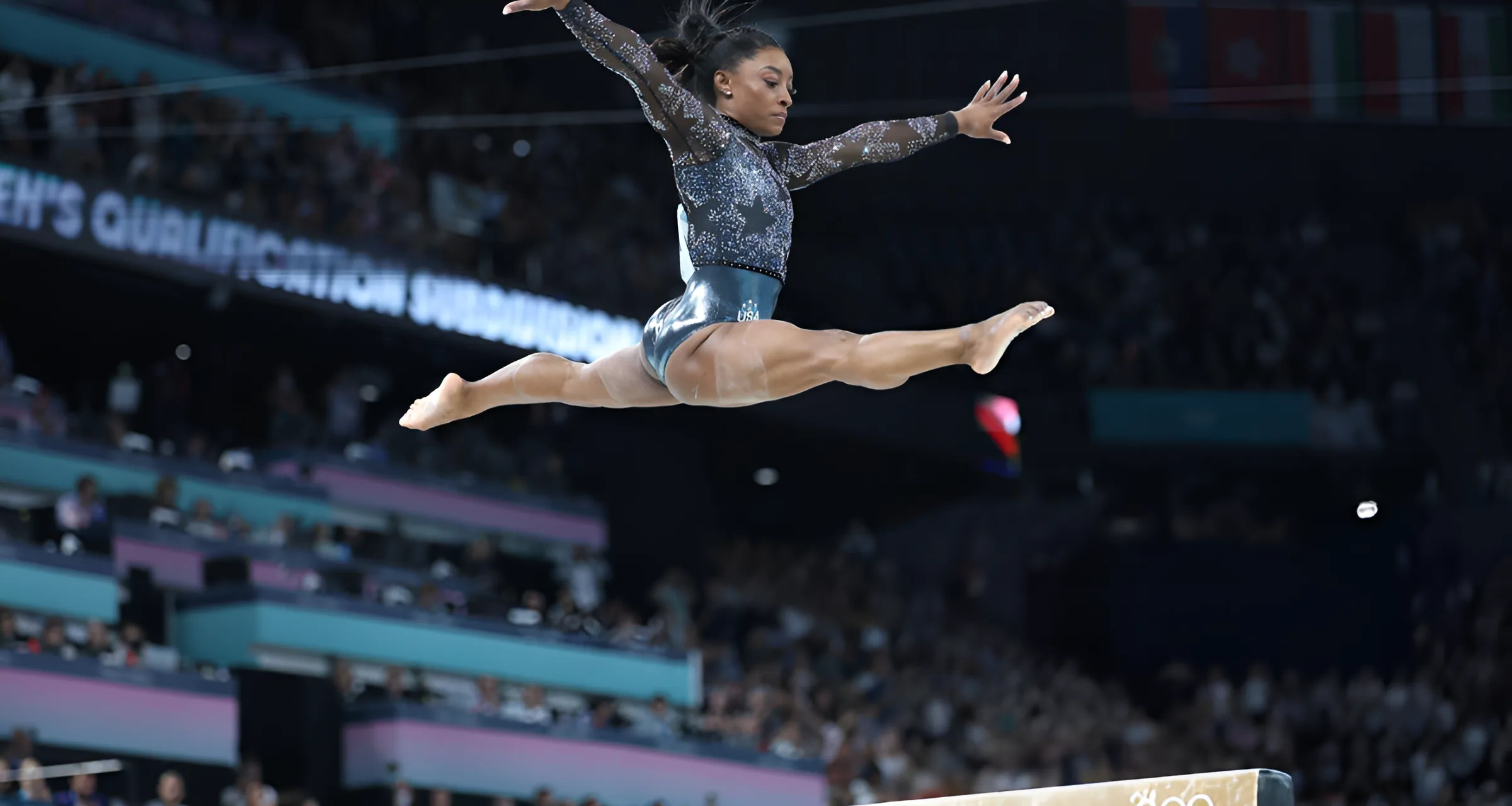 Simone Biles of Team America competes in the uneven bars event of Artistic Gymnastics during the Women's Qualification on day 2 of the Paris 2024 Olympic Games